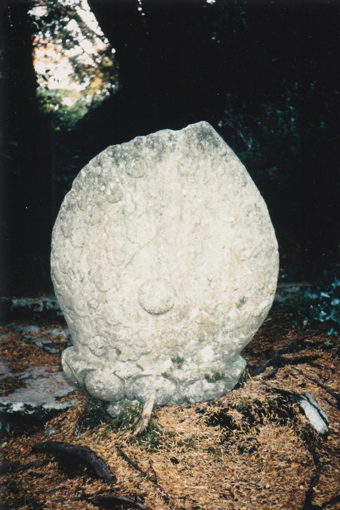 Oval sculpted stone in the garden of Muckross House